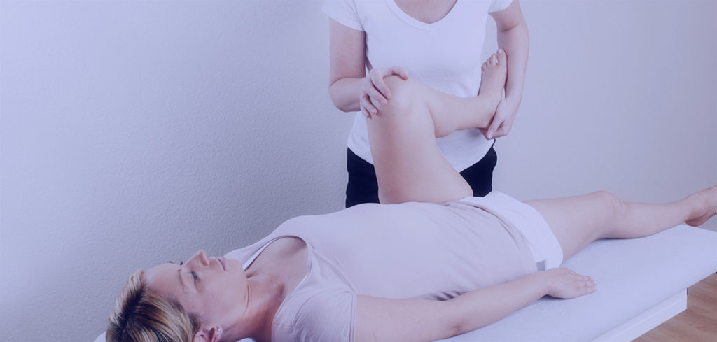 A person is getting their leg waxed by an esthetician.