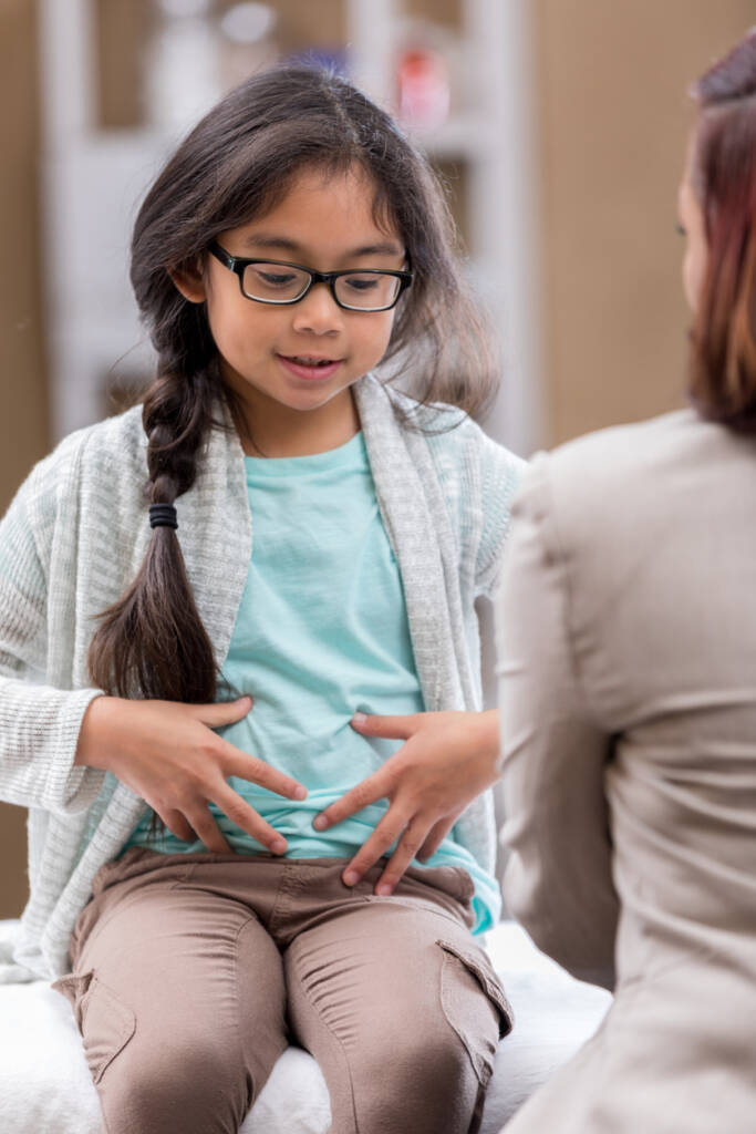 A girl with glasses is sitting down